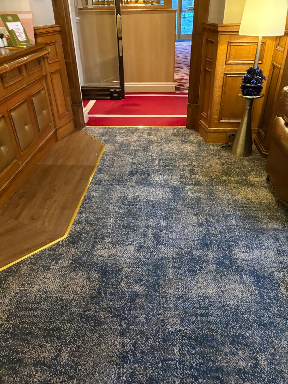 Blue and red carpet fitted through a reception and corridor